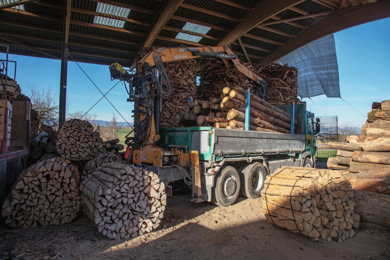 Thomas Frieden holt die Holzträmel mit einem Lastwagen mit Kranaufbau vom Wald zur Verarbeitung auf den Betrieb. Mit dem Fahrzeug werden auch die Sterbündel transportiert und gestapelt. Bild: Pia Neuenschwander