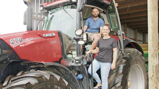 Damian und Terese Orchard in ihrem Fuhrpark. Das Lohnunternehmen besitzt zehn Landwirtschaftsfahrzeuge wie Traktoren und Mähdrescher. Während Damian die Einsätze leitet und Maschinen repariert, macht Terese die Buchhaltung. (Bild Matthias Stadler)