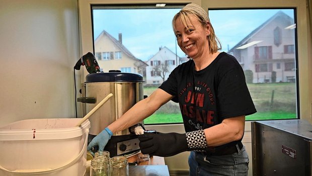 Yvonne Tschachtli füllt Brombeerkonfitüre ab. Aus zeitlichen Gründen friert sie das Obst während der Erntesaison ein und kocht die Konfitüre nach und nach bei Bedarf.  