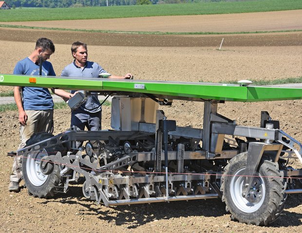 Daniel Vetterli, FiBL (links) und Marius Frei, Lenzberg precision farming testen den autonomen Farmdroid Roboter auf dem Feld. Bild: Hansueli Dierauer, FiBL