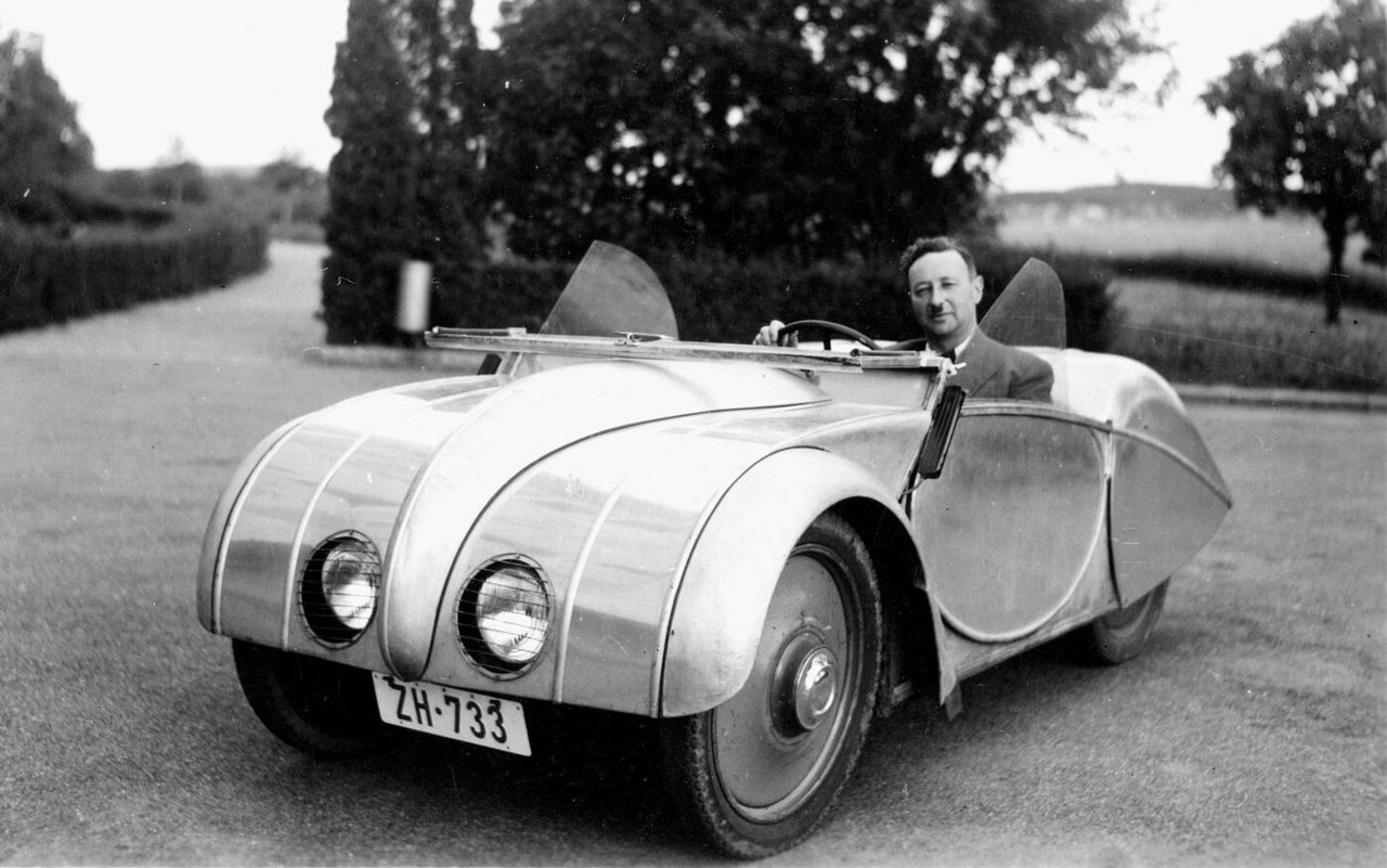 Josef Ganz am Steuer seines minimalistischen Volkswagens mit dem Spitznamen Silberfisch.